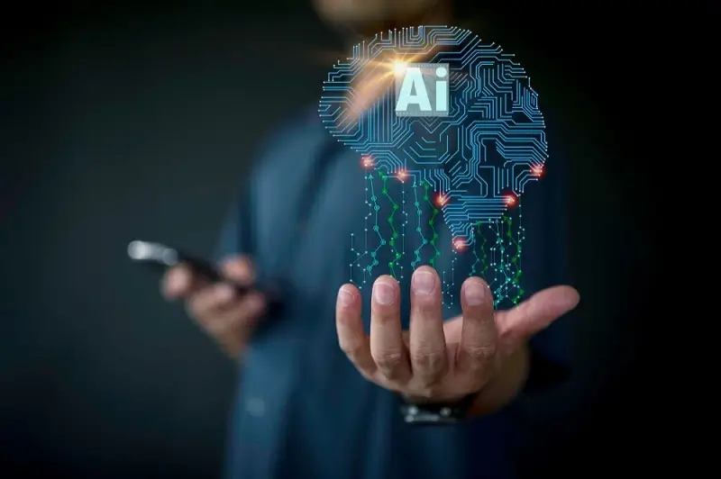 יד מחזיקה את האותיות AI